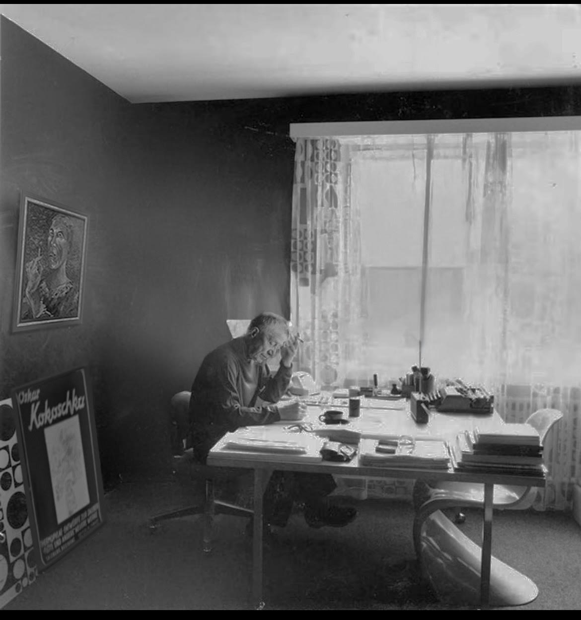 Archive photograph of a study, with Kokoschka’s Self-Portrait with a Cigarette hanging on the wall